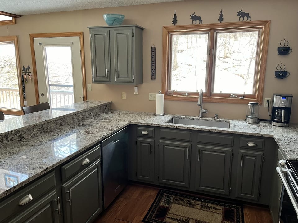 Full kitchen with granite countertops and stainless steel appliances.