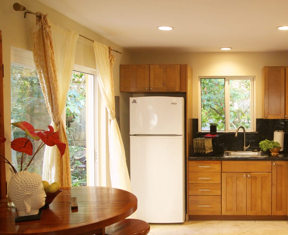 Wet bar has a refrigerator and essentials.
