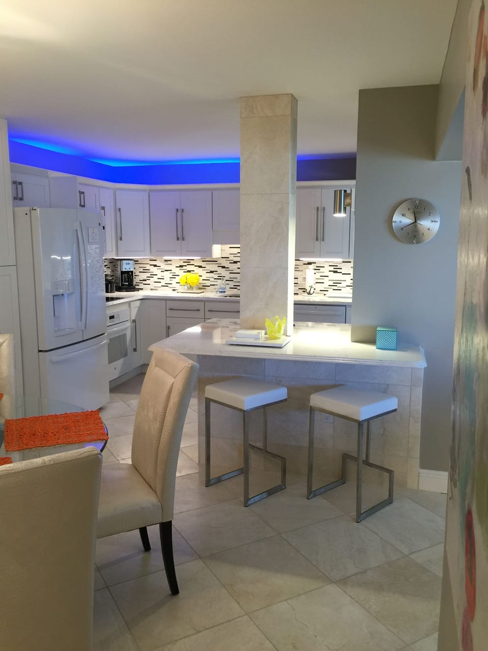 View of Kitchen from Dining Area showing bar stools and special lighting