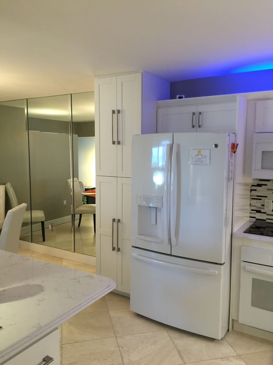 Kitchen showing new high-end refrigerator and special lighting 