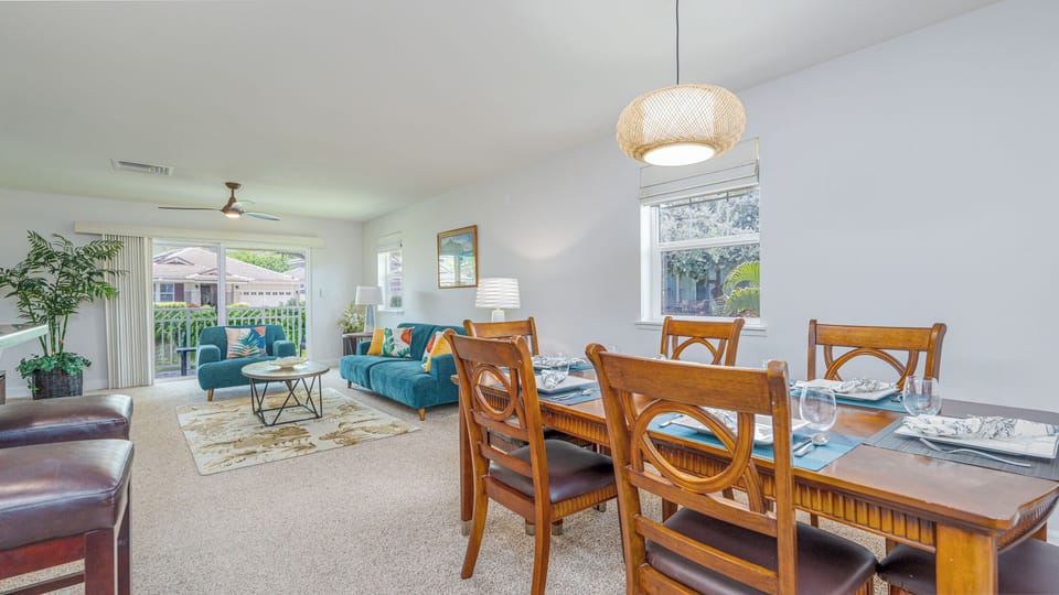 Open room layout. Dining table seats 6, and 2 barstools at kitchen counter.