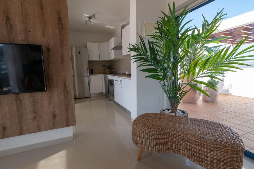Part of the living room, kitchen and one of the terraces of the villa.