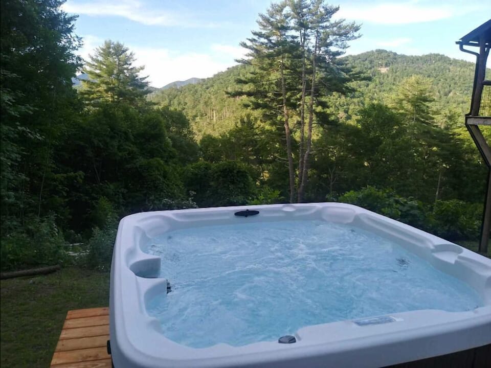 New hot tub with views next to fire pit area.