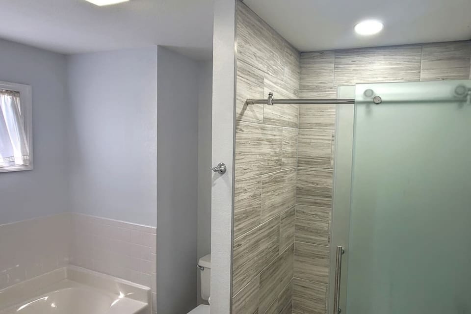 Soak in the garden tub or step into the separate tiled shower — the king master bath gives you options after a long day.