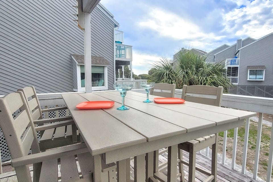 Polywood bar height table and chairs on large Main deck