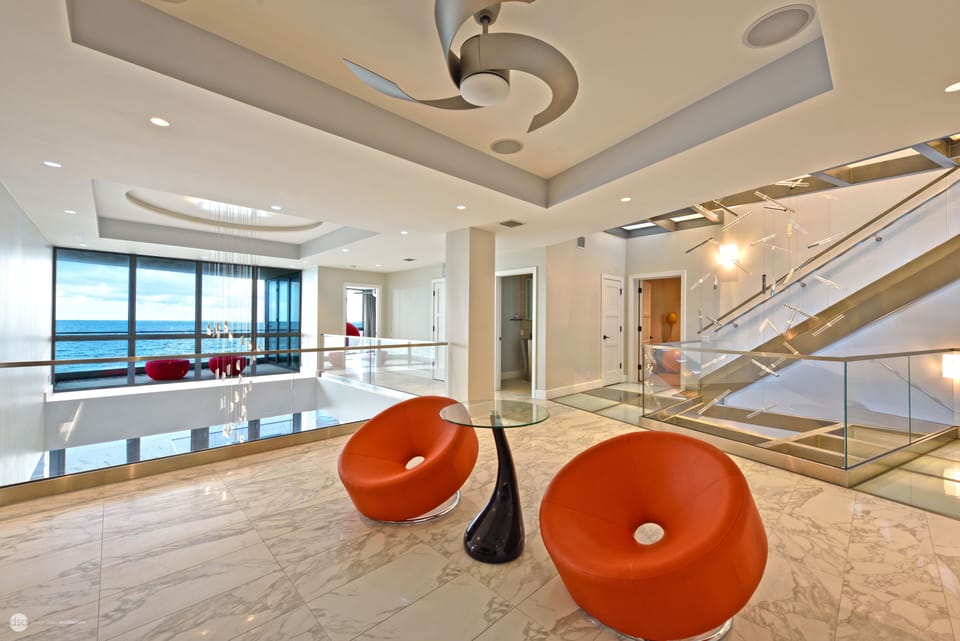 Second floor lounge. Hallway half bath, fourth bedroom beyond.