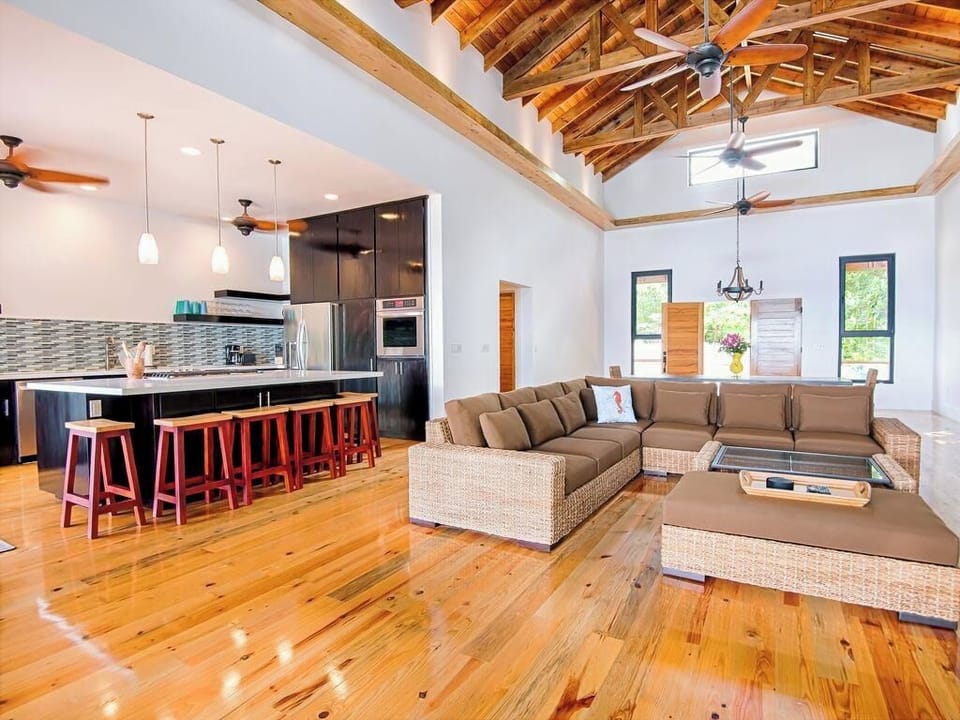 The South House great room at Vivaro is a central, open-concept space designed for both social connection and relaxation. This "modern masterpiece" focuses on a seamless indoor-outdoor lifestyle, specifically designed for groups to be "together but apart".