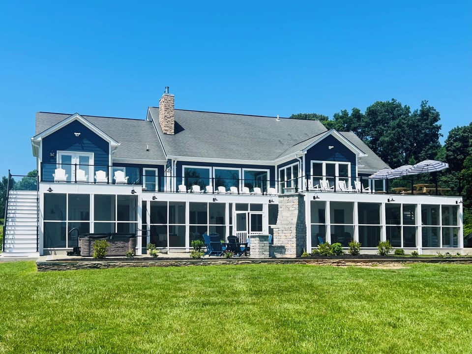 Over 5k sqft of outdoor living: deck, screen porch, two patios, and boathouse