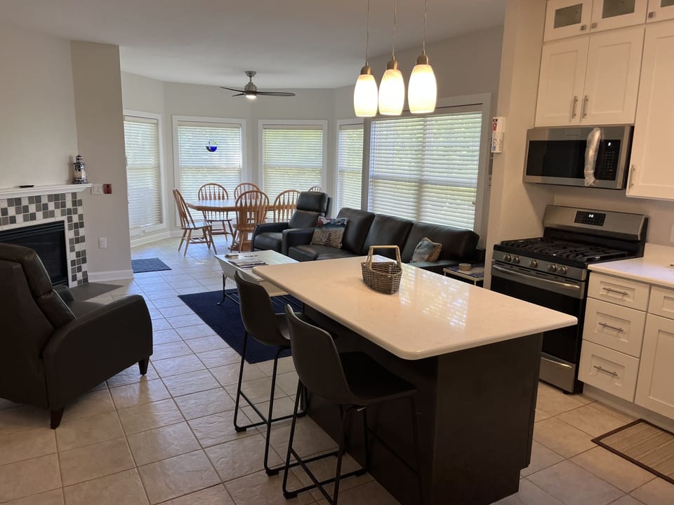 Full view of kitchen and living room - leather sofa and 2 recliners