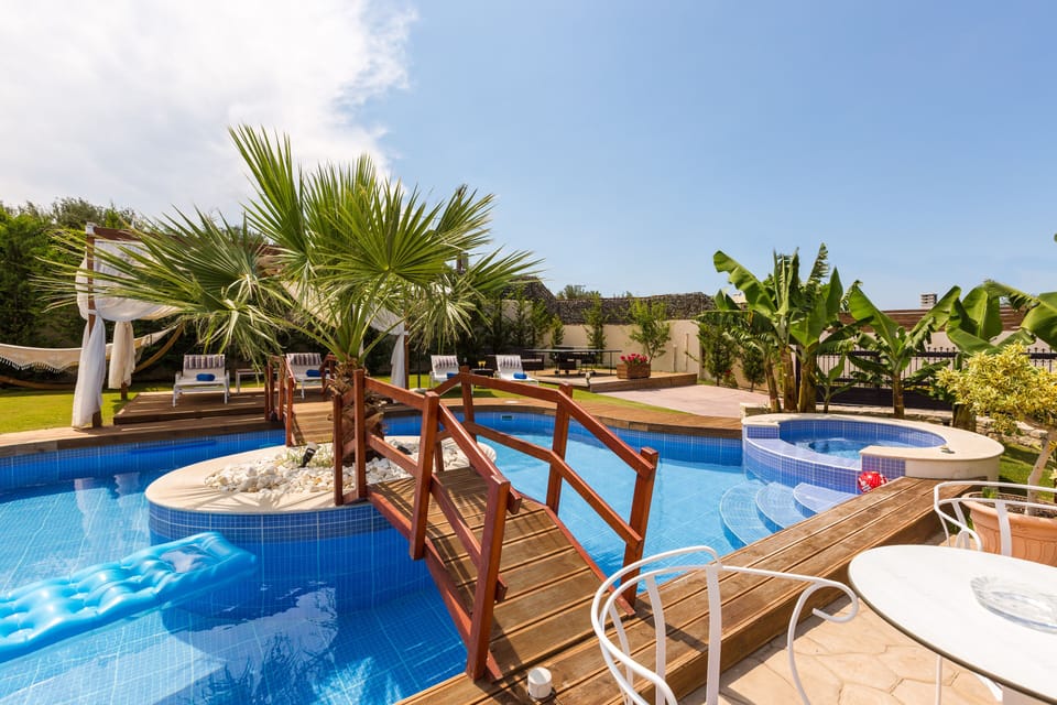 Great pool design with wooden bridge!