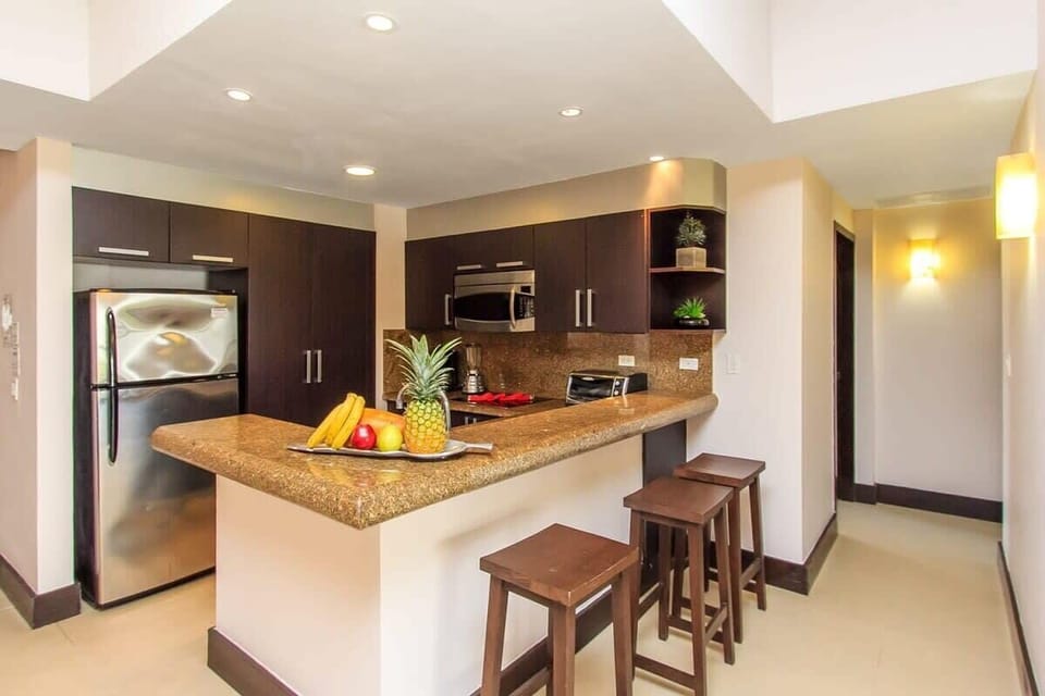 A fully-equipped kitchen w/ breakfast bar & all you'd need to prep a healthy meal at home