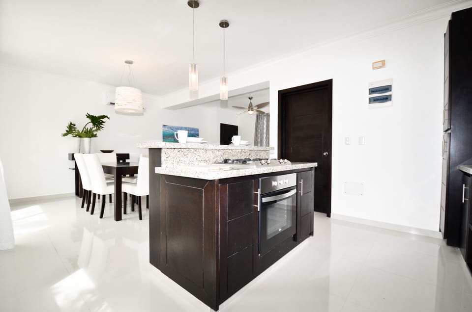 Kitchen features full size gas cooktop and electric oven.