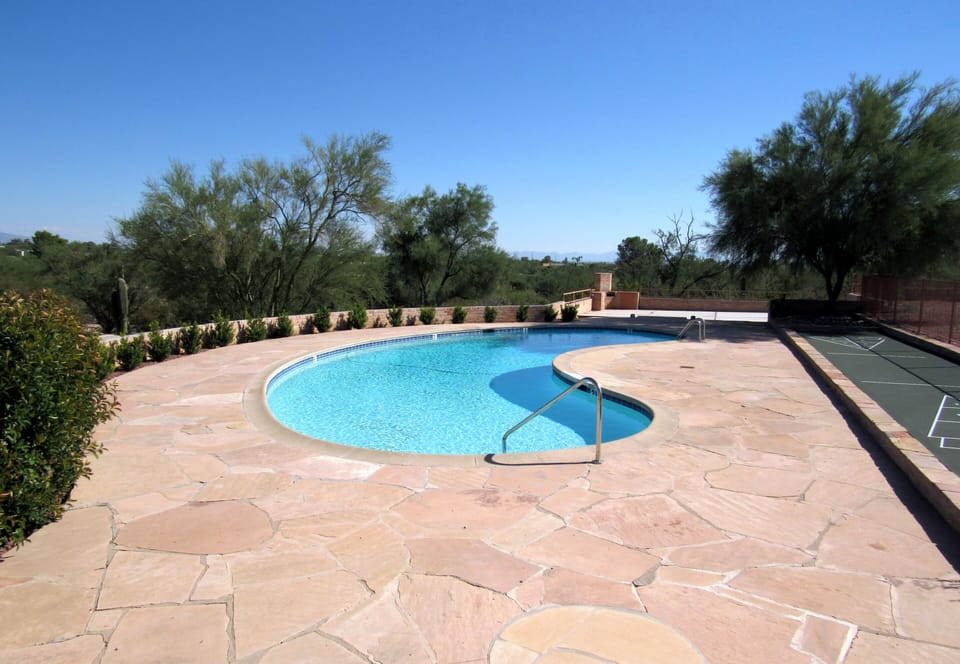 Large pool (unheated), shuffleboard, patio area beyond, blissfully quiet views. 