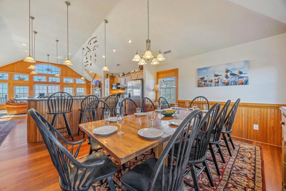 Gather around this spacious dining table where your group can share memorable meals in this warm, wood-accented space.