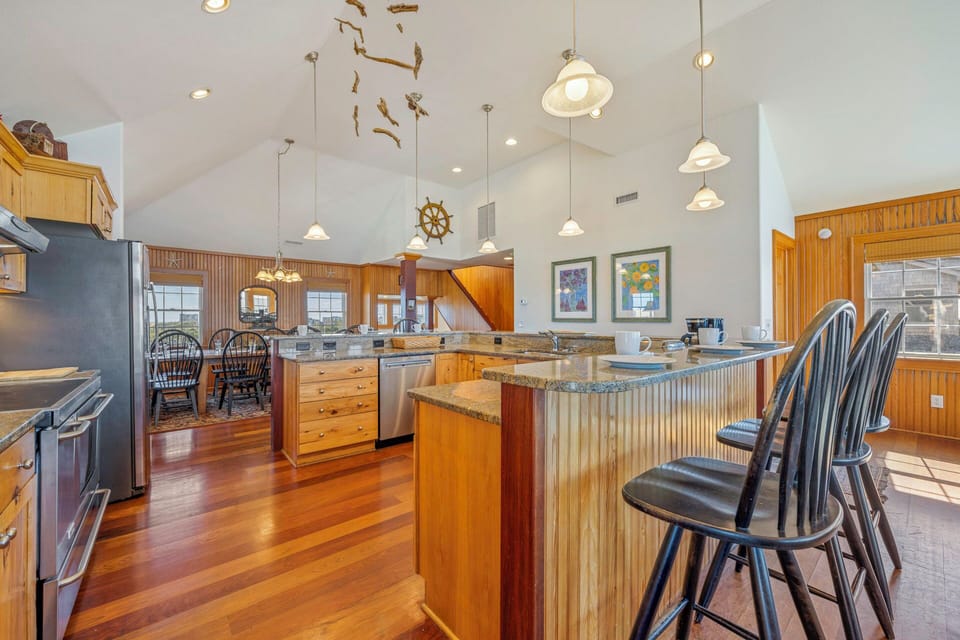 Your spacious kitchen beckons with warm wood accents, granite counters, and nautical charm—perfect for gathering with loved ones.