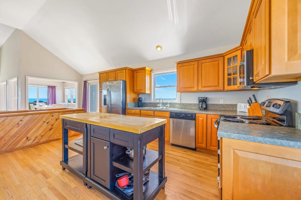 Your spacious kitchen features warm wood cabinets, granite counters, and a convenient island for all your culinary adventures.
