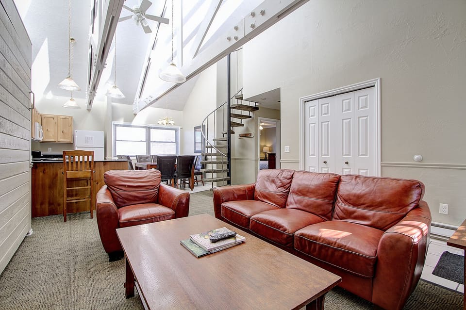 Living Rm. Looking at kitchen, dining area, circular stairs to top bed & bath