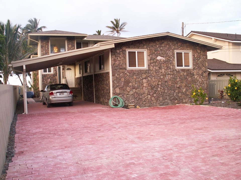 Front with carport and parking area