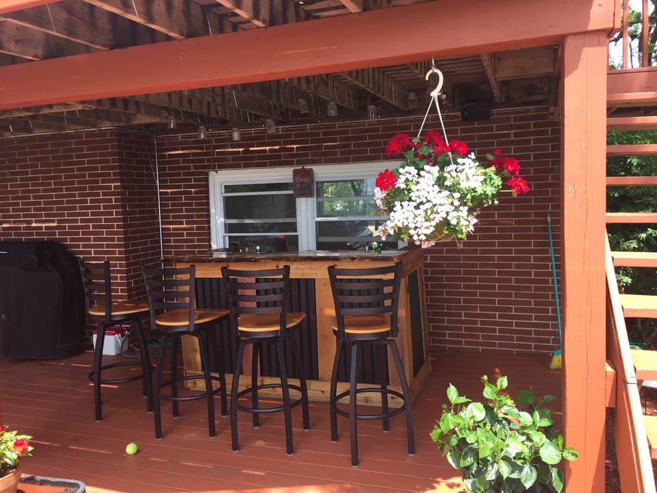 Outdoor bar area with a refrigerator. 
