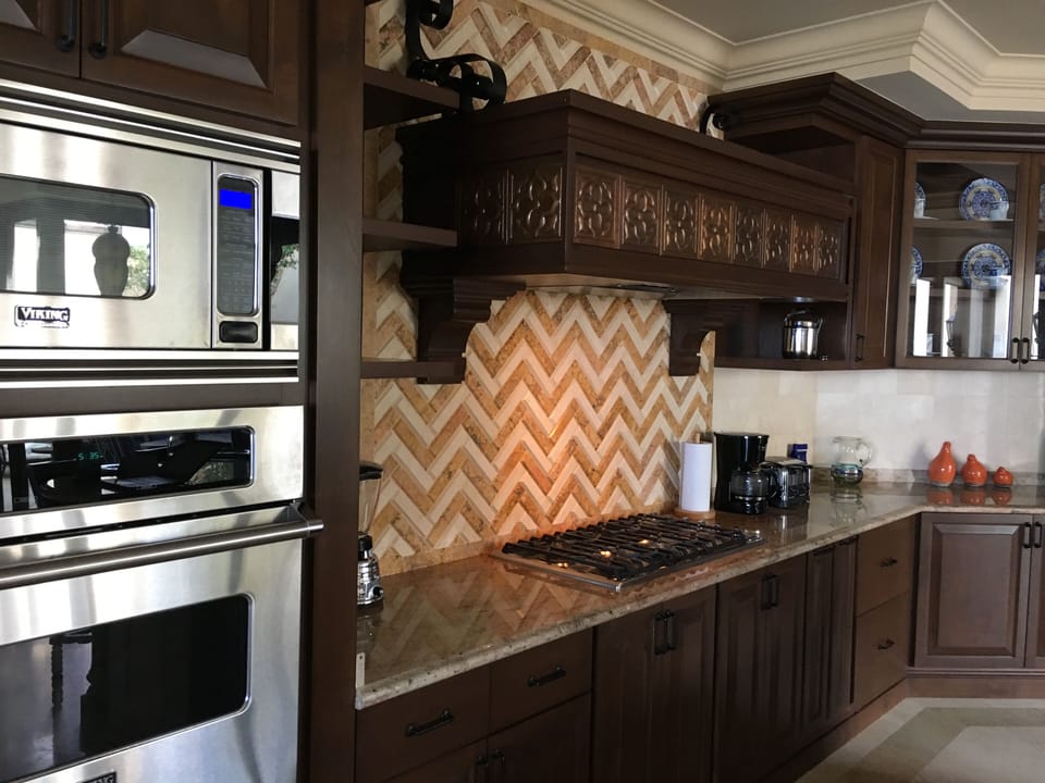 Custom hand-laid tile, marble floors & Viking appliances with a big island…