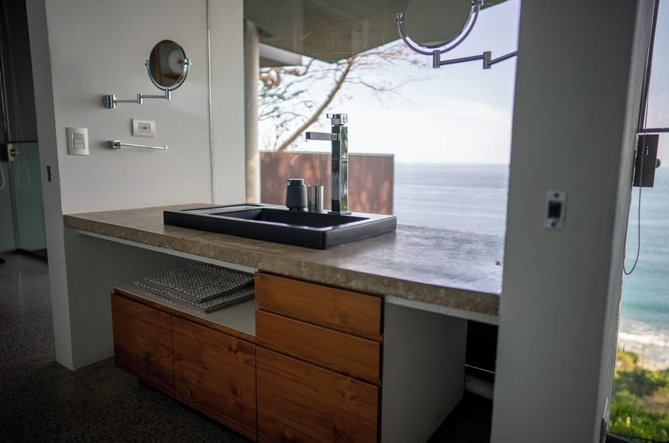 Jack and Jill Bathroom that connects the two guest bedrooms of Casa Cocobolo. Full bathroom with standup shower.