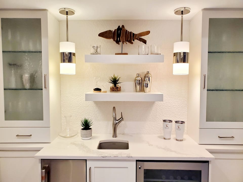 Indoor bar with ice make and refrigerator across from indoor dining area