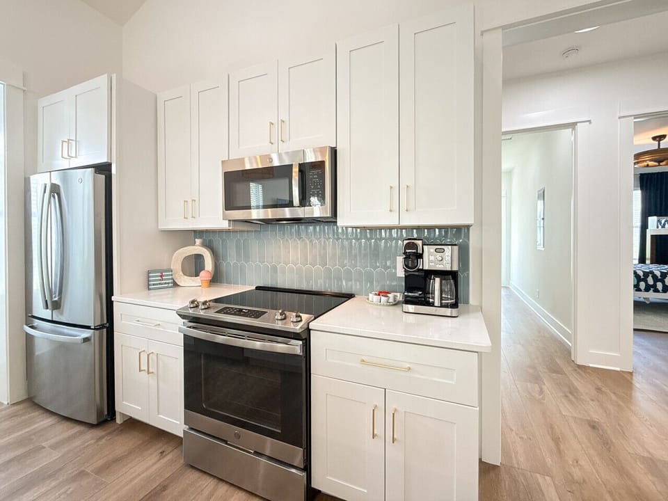 Brand-new kitchen with state-of-the-art appliances, cozy desk nook, and pantry.