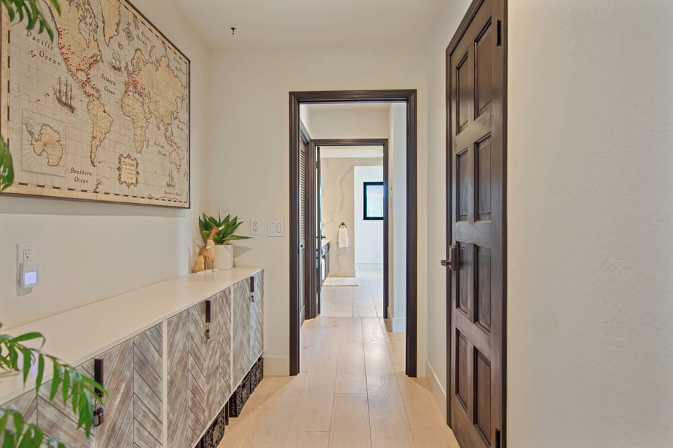 Top floor primary bedroom hall to en suite bath, private deck epic views