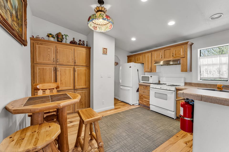 The kitchen is equipped with a stove, microwave, coffee machine, and dishwasher