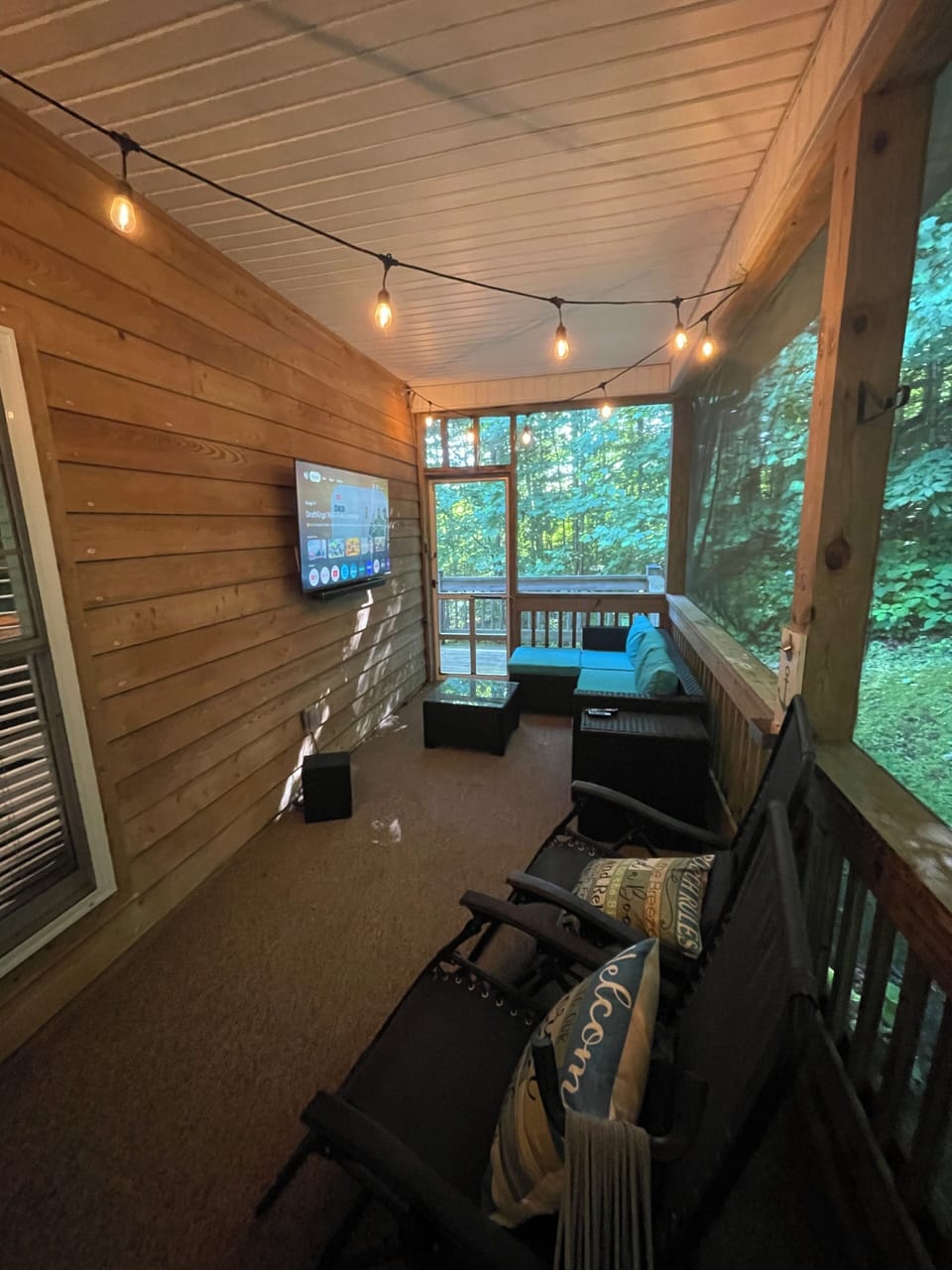Sofa, TV and Soundbar on rear porch.