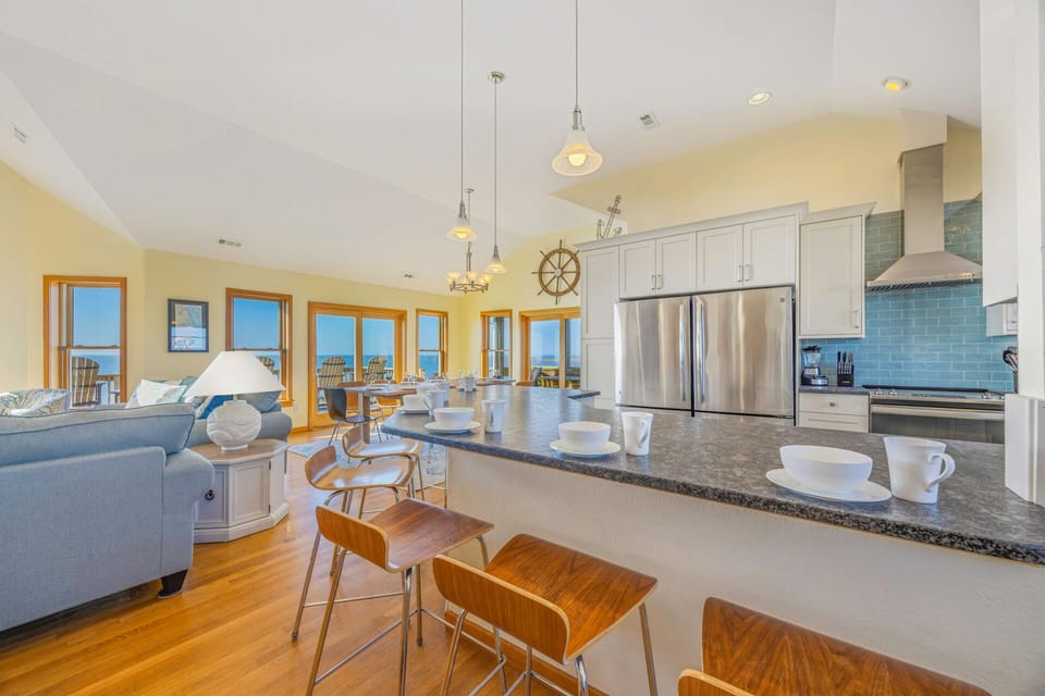 Your open-concept kitchen flows seamlessly into the living space, featuring granite countertops and modern appliances perfect for cooking together.