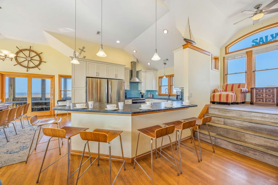 Your spacious kitchen island becomes the heart of gatherings, with nautical touches and panoramic windows framing endless views.