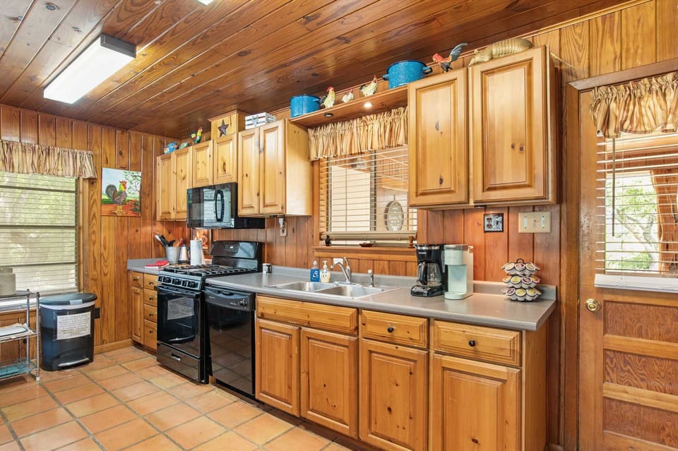Your full country kitchen includes a range top and oven, fridge, microwave, coffee maker, and toaster.