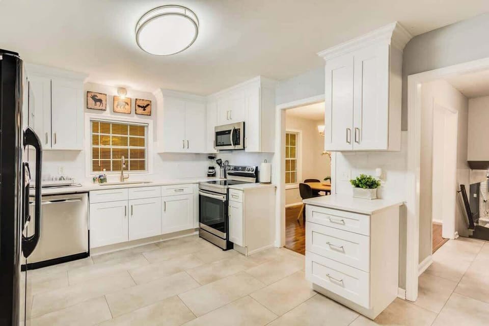 This modern and sleek kitchen is a chef's dream, with plenty of counter space and all the latest gadgets and tools.