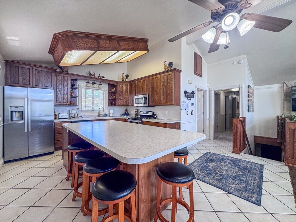 Spacious kitchen with oversized island seating, perfect for meals, conversation, and gathering together.