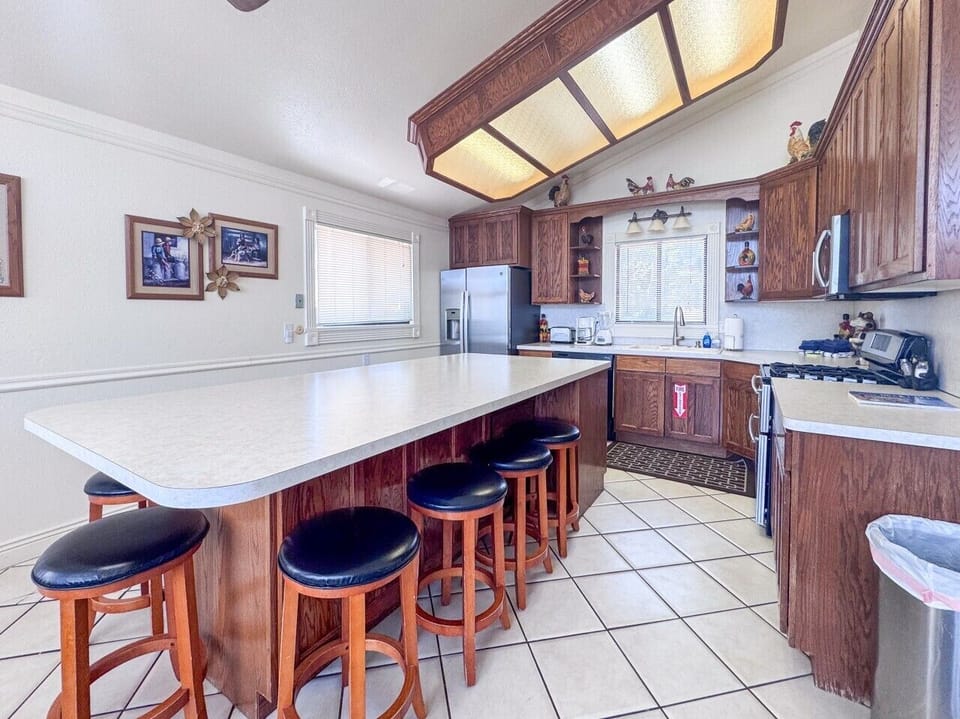 Spacious kitchen with oversized island seating, perfect for meals, conversation, and gathering together.