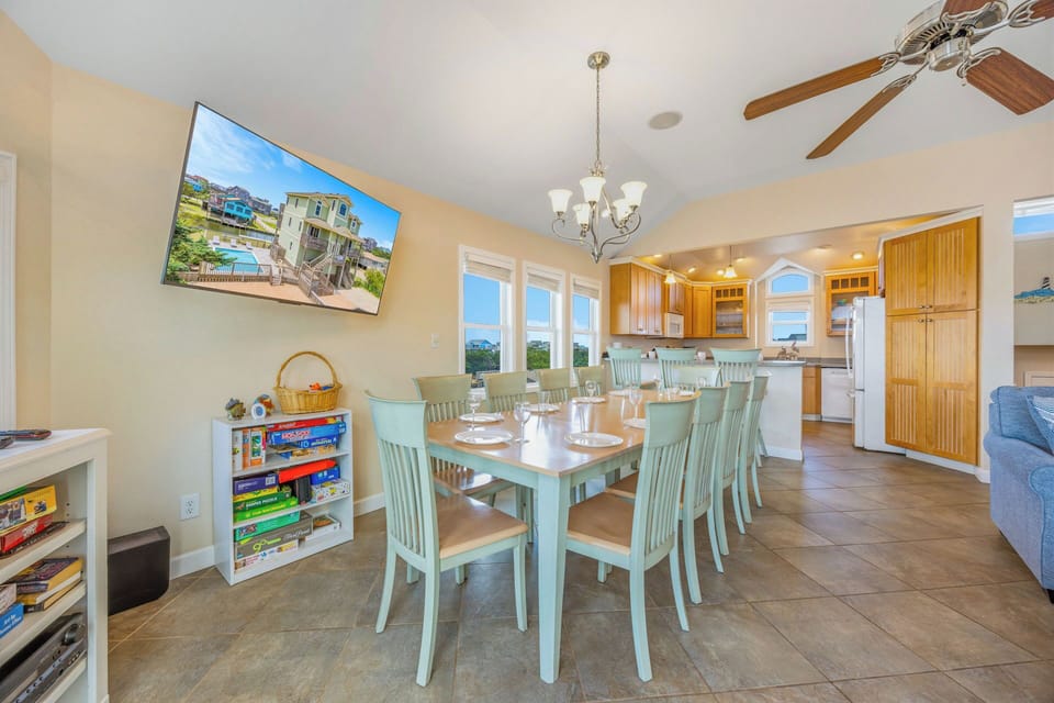 Gather around the spacious dining table for shared meals and laughter, with coastal breezes from three windows and an open kitchen just steps away inviting effortless entertaining.