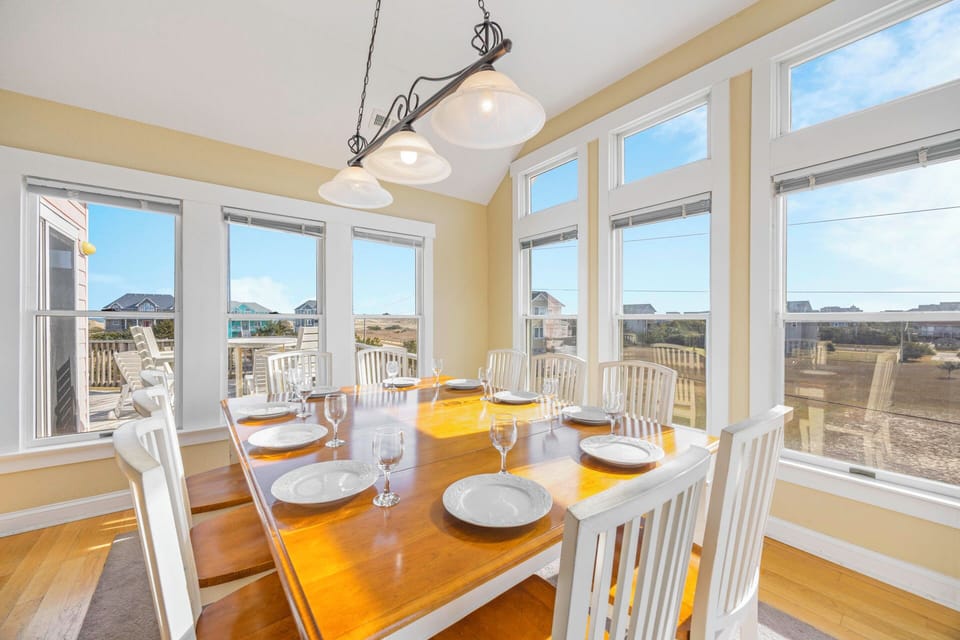 Gather around this sunlit dining table for memorable meals with sweeping views of the coastal landscape beyond your windows.