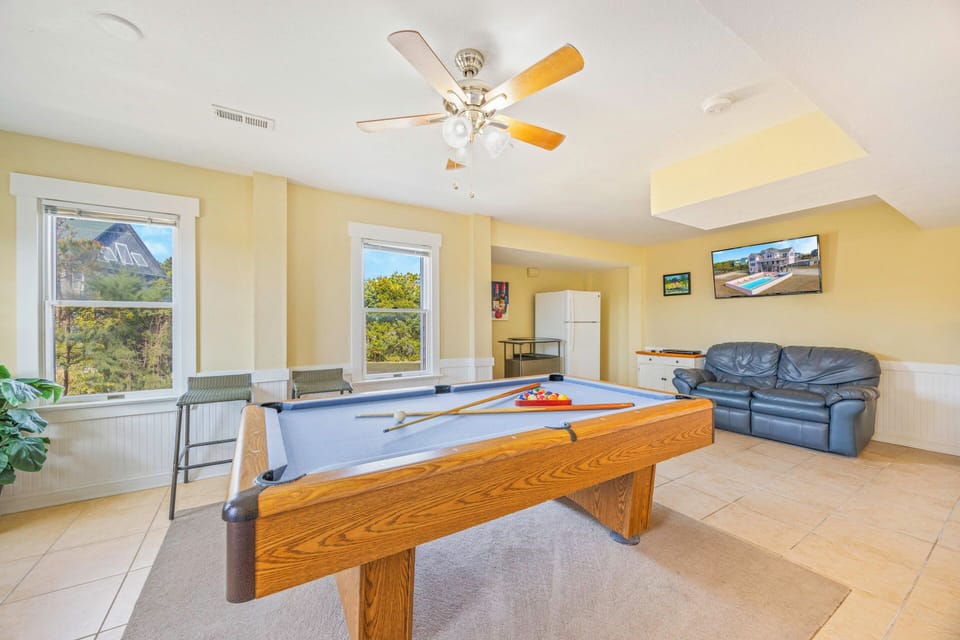 Challenge friends to a game of pool in this bright, cheerful game room with comfy seating for spectators and scenic views.