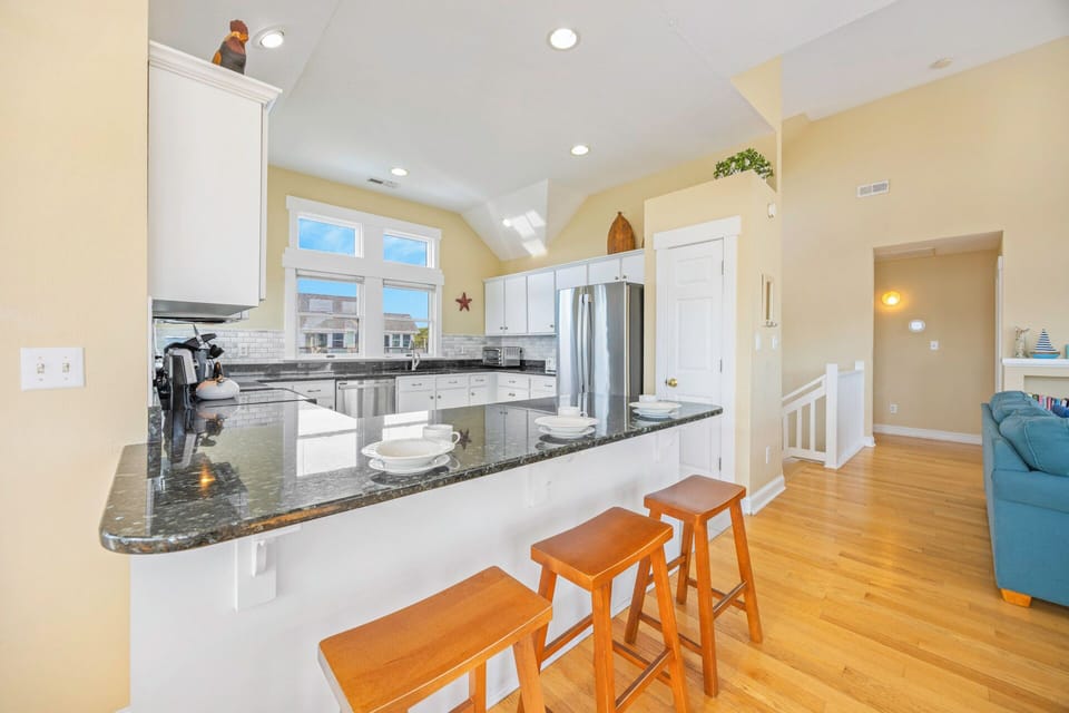 Your spacious gourmet kitchen features granite countertops, stainless steel appliances, and a breakfast bar perfect for morning coffee or casual dining.