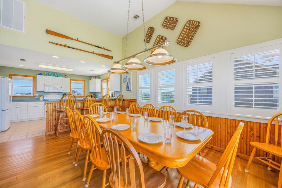 Gather around your spacious dining table where coastal charm meets comfort, perfect for sharing memorable meals with your group.