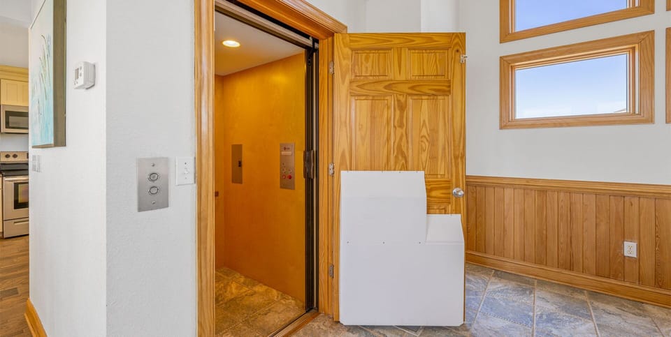Surf or Sound Realty - 613 - Clear Skies - Elevator - Label