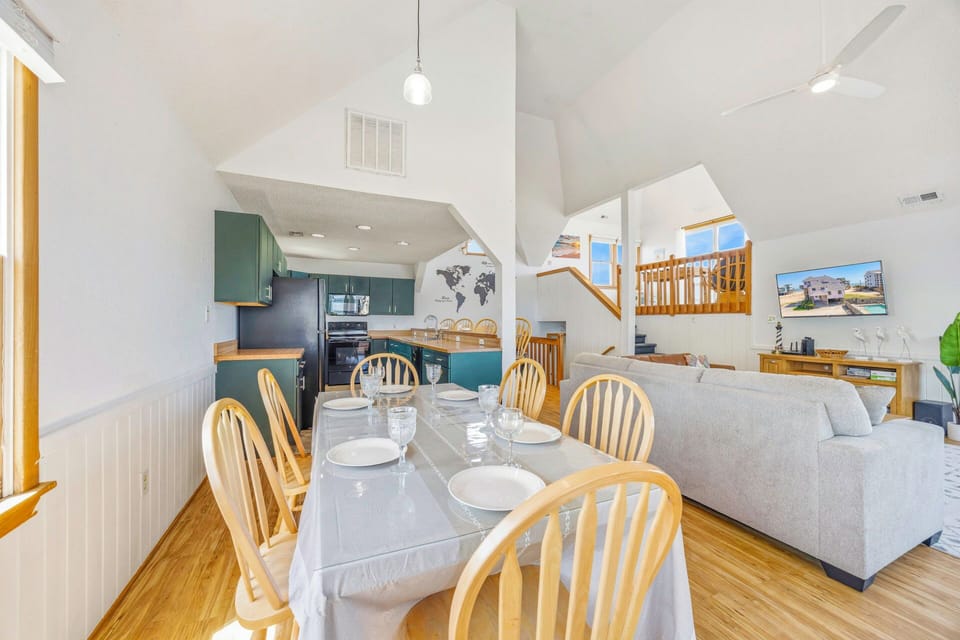 Your open-concept living space seamlessly blends kitchen, dining, and lounge areas with warm wood accents and modern comfort for memorable gatherings.