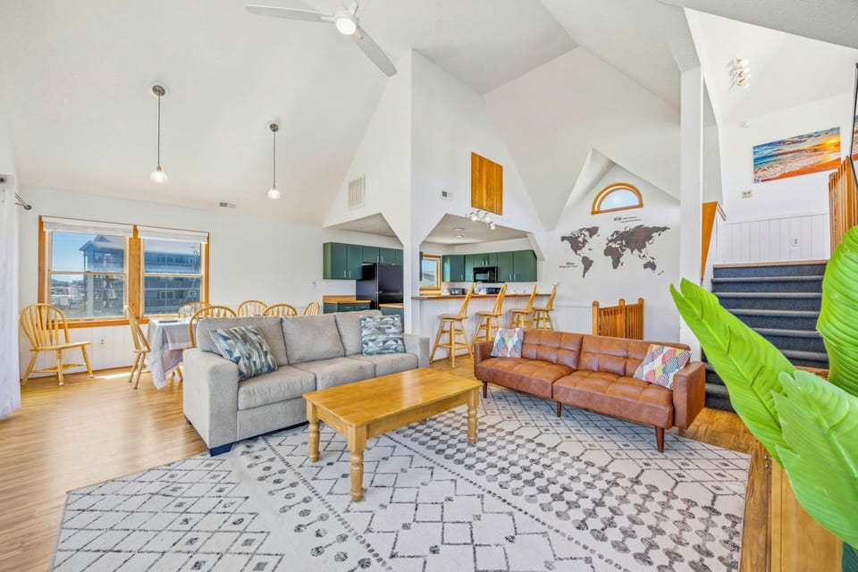 Unwind in your spacious open living area with vaulted ceilings, cozy seating, and a fully equipped kitchen perfect for memorable meals together.