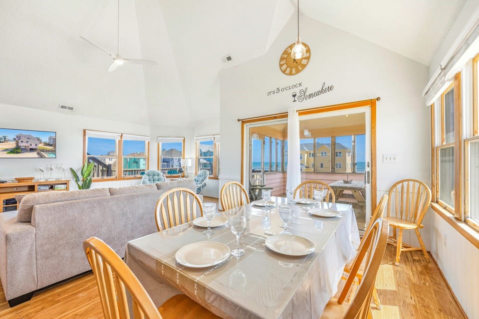 Your bright dining space flows seamlessly into the living area, where sunlight streams through large windows as you gather for memorable meals together.