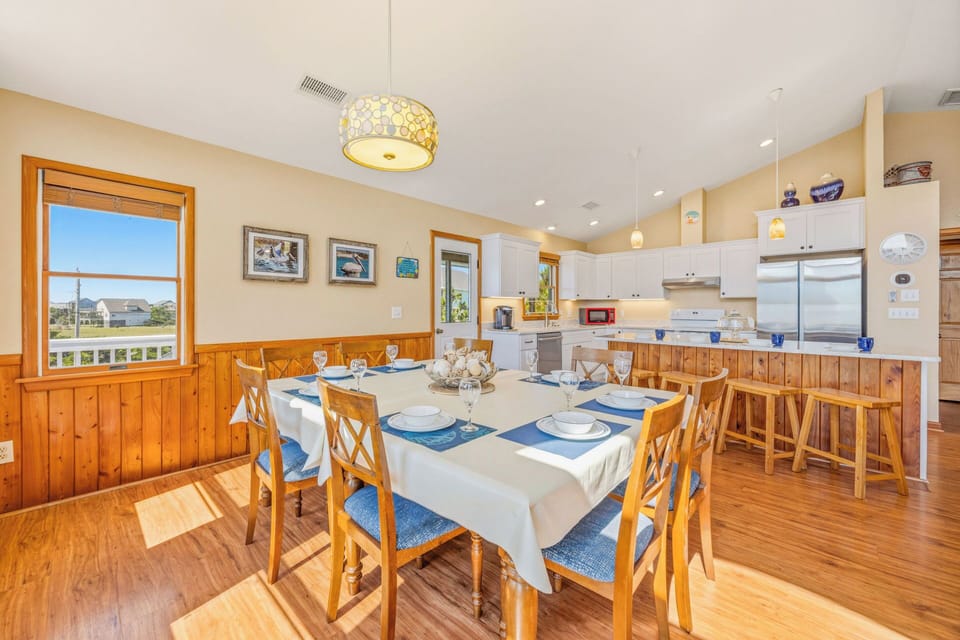 Gather your group around the inviting dining table, beautifully set and flooded with natural light, while you prepare home-cooked meals in the bright, fully equipped kitchen just steps away.