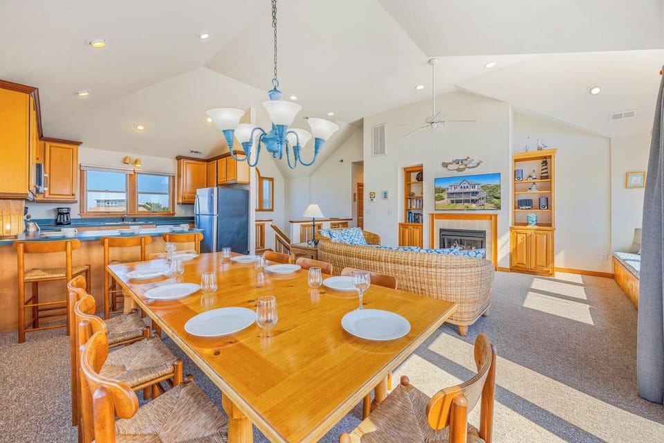 Gather around this spacious dining table where your group can share meals together, with the kitchen, living room, and fireplace all within easy reach for effortless entertaining.