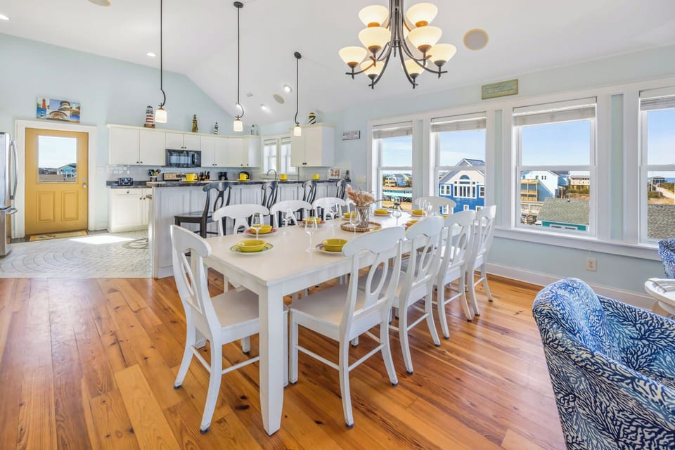 Enjoy your meals around the 10-person dining table, with additional seats available at the 4-person breakfast bar.