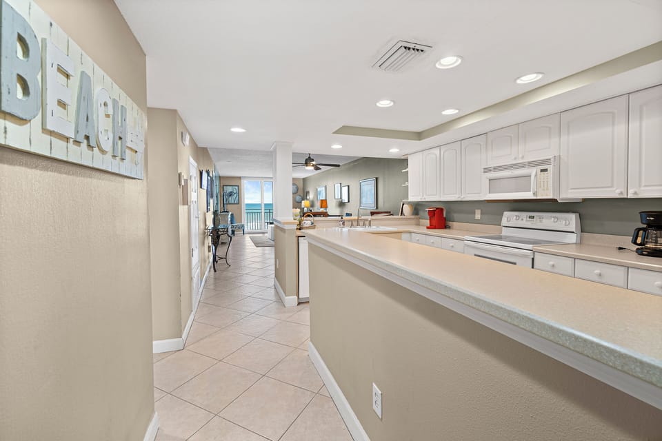 entry hallway leads into full kitchen