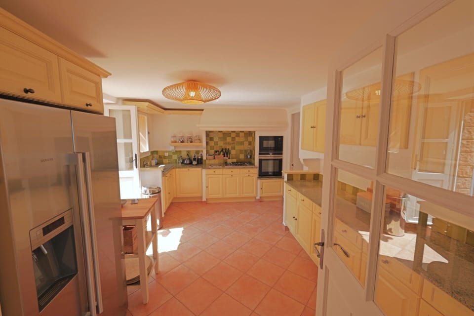 Lower floor: Classic picturesque French kitchen with American fridge.